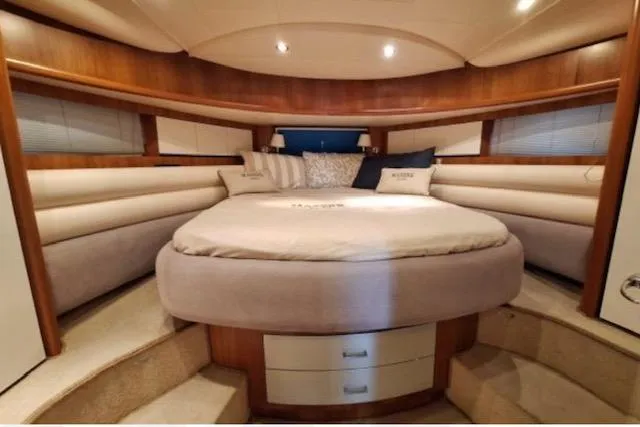  Yacht Photos Pics Luxurious cabin interior of 2003 Cayman Yachts 55-58 Walkaround HT with cozy bed and elegant wood finish.