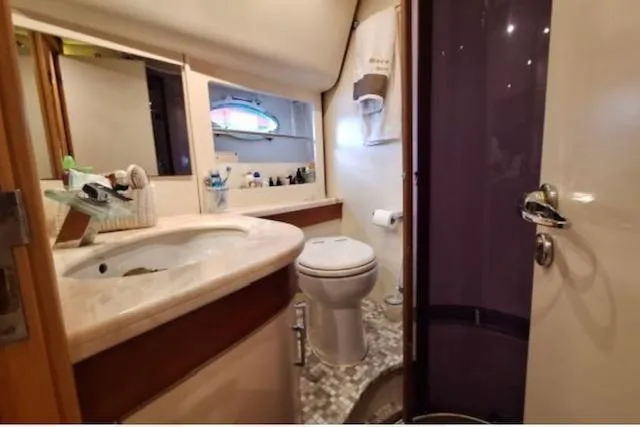 Yacht Photos Pics Luxurious bathroom in 2003 Cayman Yachts 55-58 Walkaround HT, featuring modern amenities.