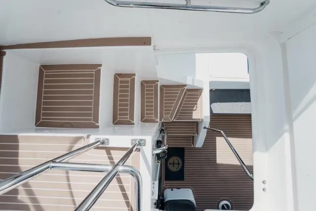 Catfish Yacht Photos Pics Staircase on 2017 Leopard 51 Powercat with sleek wooden finish and stainless steel railings.