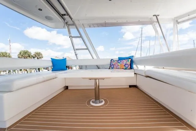 Catfish Yacht Photos Pics 2017 Leopard 51 Powercat yacht deck with white seating, colorful cushions, and wooden flooring.