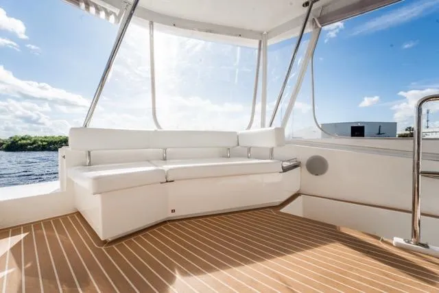 Catfish Yacht Photos Pics 2017 Leopard 51 Powercat interior with white seating and wooden flooring.