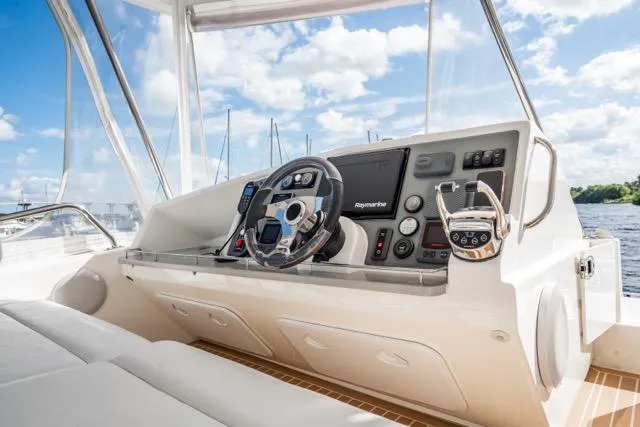 Catfish Yacht Photos Pics Helm of 2017 Leopard 51 Powercat with modern navigation equipment and scenic water view.