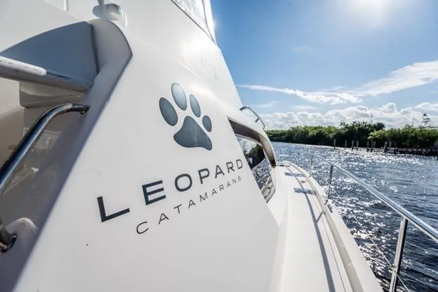 Catfish Yacht Photos Pics 2017 Leopard 51 Powercat catamaran cruising on a sunny day, featuring sleek design and branding.