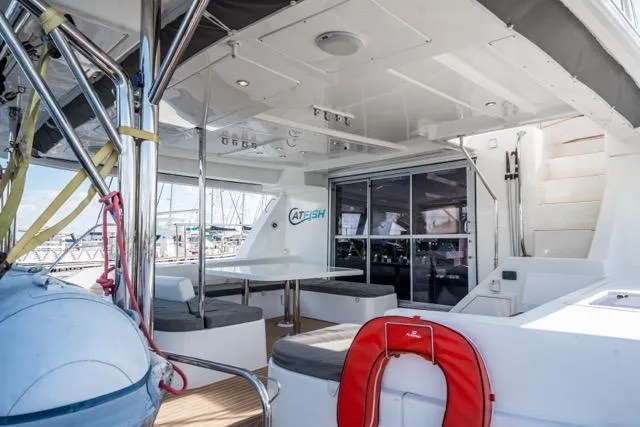 Catfish Yacht Photos Pics 2017 Leopard 51 Powercat yacht deck with seating, life preserver, and marina view.