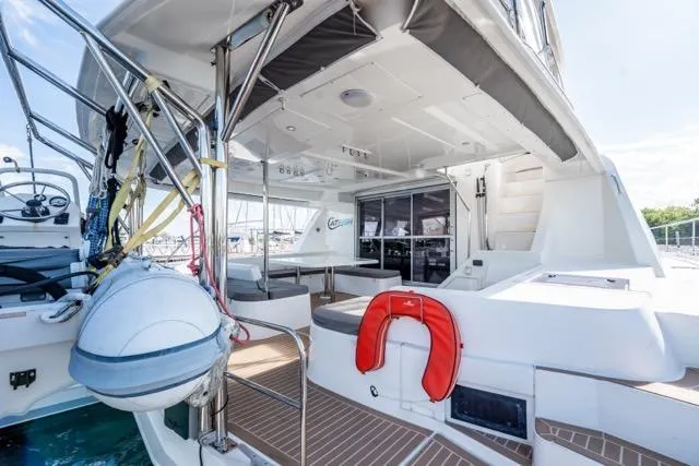 Catfish Yacht Photos Pics 2017 Leopard 51 Powercat yacht deck with seating, life preserver, and helm station.