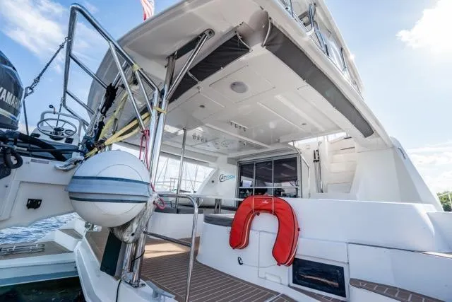 Catfish Yacht Photos Pics 2017 Leopard 51 Powercat yacht stern view with life preserver and deck details.