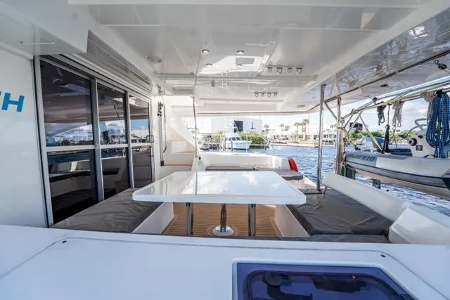 Catfish Yacht Photos Pics Spacious deck of 2017 Leopard 51 Powercat with seating and table, overlooking marina.