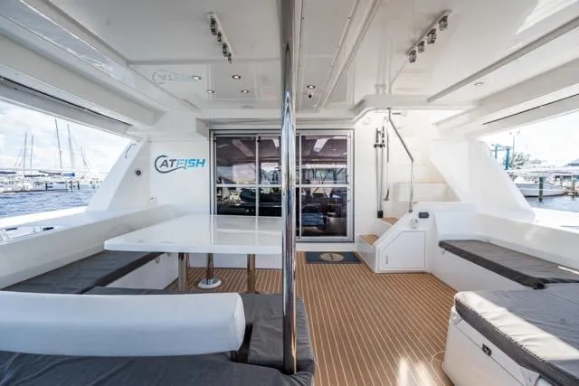 Catfish Yacht Photos Pics Spacious interior of 2017 Leopard 51 Powercat yacht with modern seating and table.