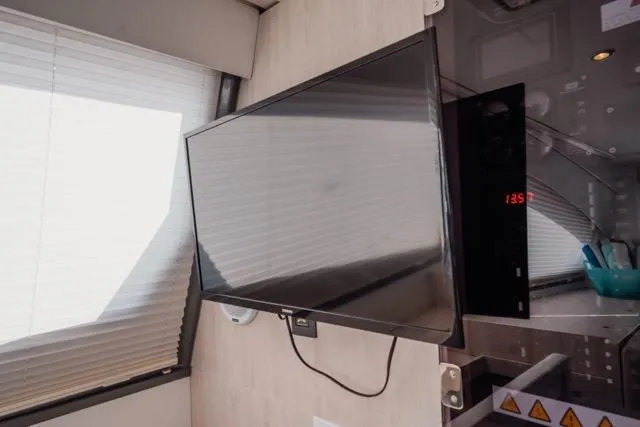 Catfish Yacht Photos Pics Wall-mounted TV in 2017 Leopard 51 Powercat interior, near window blinds.