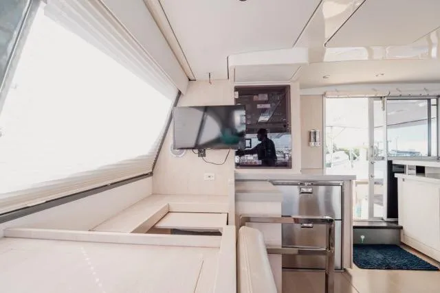 Catfish Yacht Photos Pics Interior of 2017 Leopard 51 Powercat yacht with modern furnishings and a mounted TV.