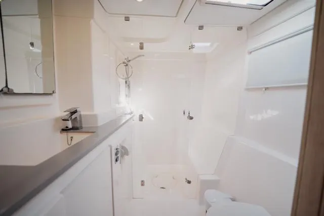 Catfish Yacht Photos Pics Luxurious bathroom in 2017 Leopard 51 Powercat yacht, featuring modern fixtures and sleek design.