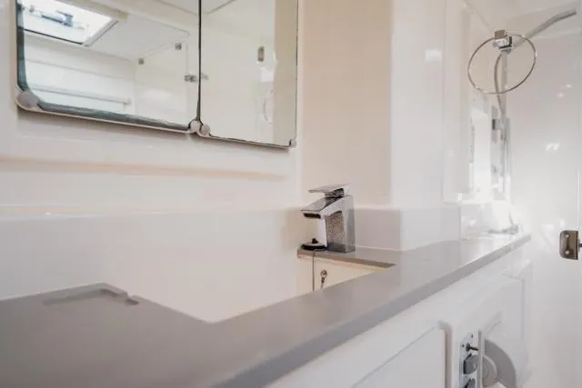 Catfish Yacht Photos Pics Modern bathroom interior on 2017 Leopard 51 Powercat yacht, featuring sleek fixtures and mirror.