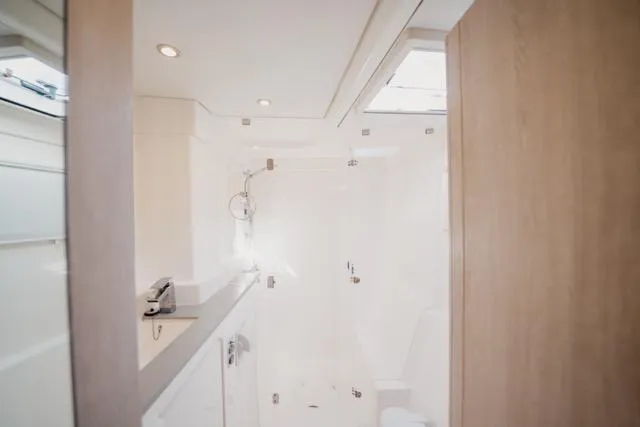 Catfish Yacht Photos Pics Luxurious bathroom interior of 2017 Leopard 51 Powercat yacht, featuring modern fixtures and natural lighting.