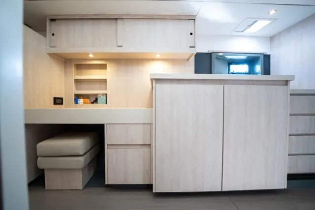 Catfish Yacht Photos Pics Interior of 2017 Leopard 51 Powercat with modern cabinetry and seating area.