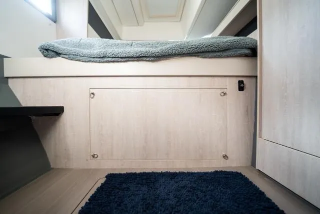 Catfish Yacht Photos Pics 2017 Leopard 51 Powercat interior cabin with bed and blue rug.