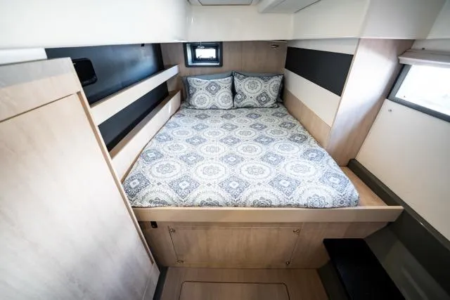 Catfish Yacht Photos Pics 2017 Leopard 51 Powercat cabin with patterned bedding and modern wood finish.