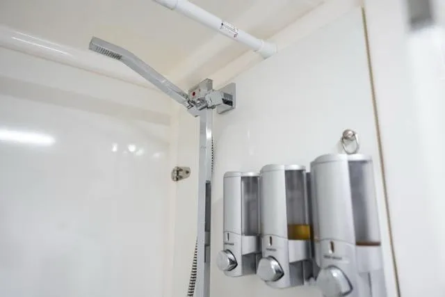 Catfish Yacht Photos Pics Shower area in 2017 Leopard 51 Powercat with modern dispensers and sleek fixtures.