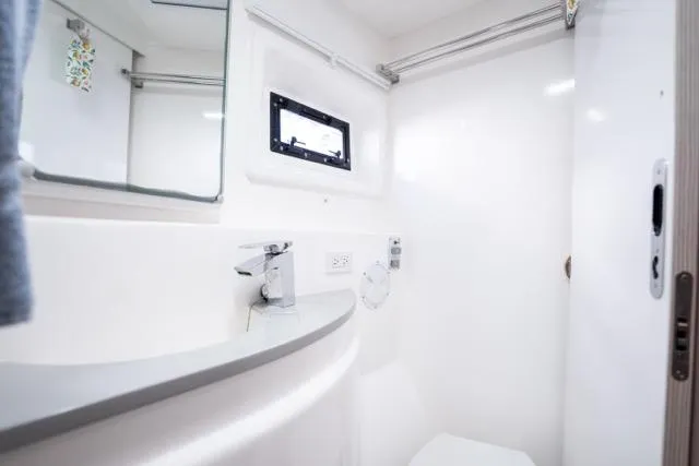 Catfish Yacht Photos Pics Modern bathroom interior on 2017 Leopard 51 Powercat yacht, featuring sleek design and compact amenities.