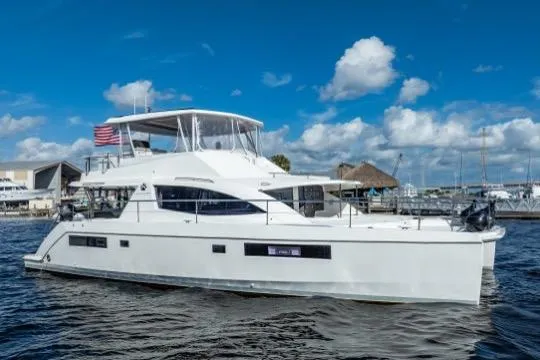 Catfish Yacht Photos Pics 2017 Leopard 51 Powercat yacht on water under blue sky with clouds.