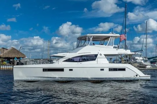 Catfish Yacht Photos Pics 2017 Leopard 51 Powercat yacht docked, featuring sleek design and American flag, under blue sky.