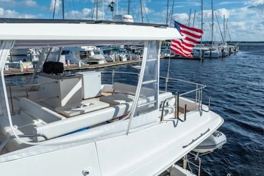 Catfish Yacht Photos Pics 2017 Leopard 51 Powercat yacht docked, featuring spacious deck and American flag.