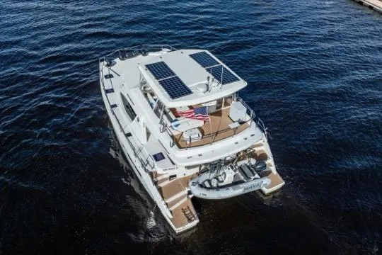 Catfish Yacht Photos Pics 2017 Leopard 51 Powercat yacht with solar panels on water, aerial view.