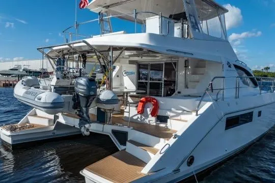 Catfish Yacht Photos Pics 2017 Leopard 51 Powercat yacht docked, featuring twin outboard motors and spacious deck.