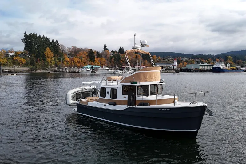  Yacht Photos Pics 2021 Ranger Tugs R-31 CB boat on calm water, surrounded by autumn trees.