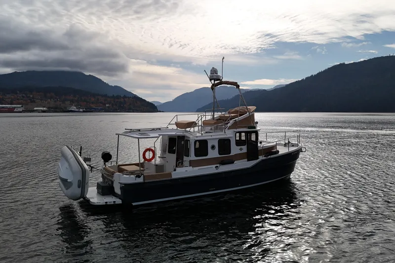  Yacht Photos Pics 2021 Ranger Tugs R-31 CB boat on scenic lake with mountainous backdrop.