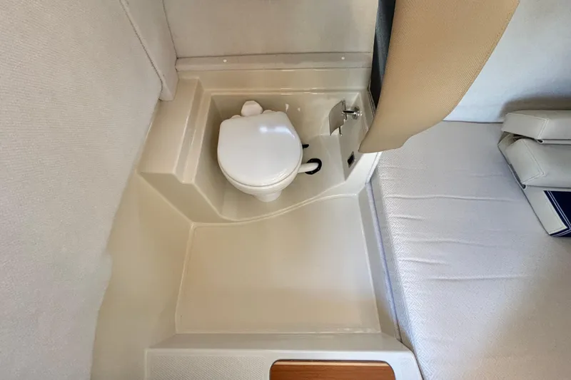  Yacht Photos Pics 2021 Ranger Tugs R-31 CB interior with compact marine toilet and seating area.