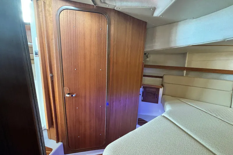  Yacht Photos Pics 2021 Ranger Tugs R-31 CB interior cabin with wooden door and cozy seating area.