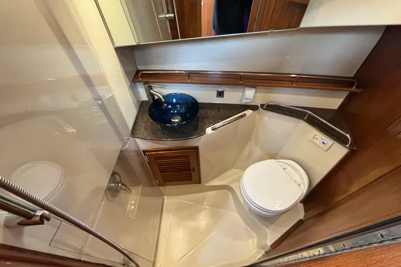  Yacht Photos Pics 2021 Ranger Tugs R-31 CB bathroom with modern sink and compact toilet.