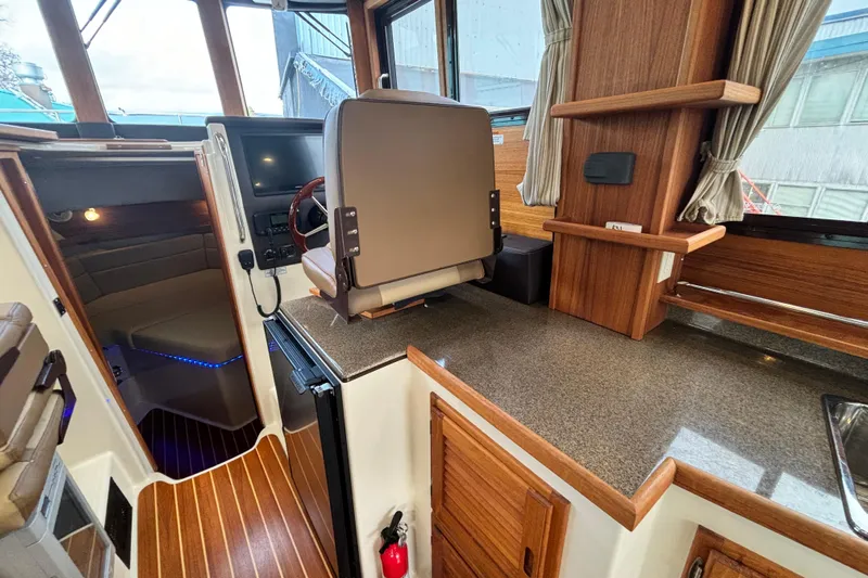  Yacht Photos Pics 2021 Ranger Tugs R-31 CB interior with wood accents and modern helm station.