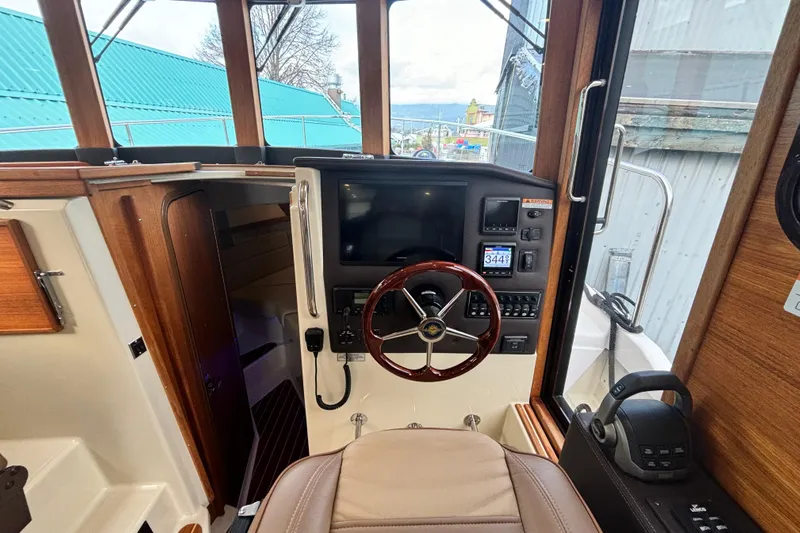  Yacht Photos Pics Interior helm of 2021 Ranger Tugs R-31 CB with modern controls and wooden accents.