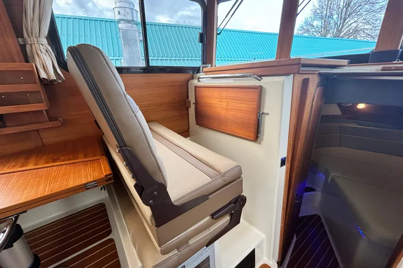  Yacht Photos Pics 2021 Ranger Tugs R-31 CB interior with wood accents and seating.