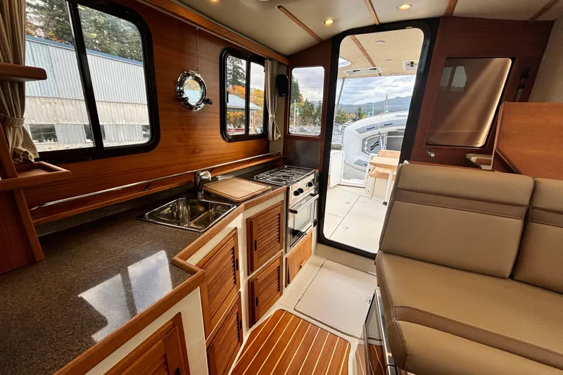  Yacht Photos Pics Interior of 2021 Ranger Tugs R-31 CB, featuring a modern kitchen and seating area.