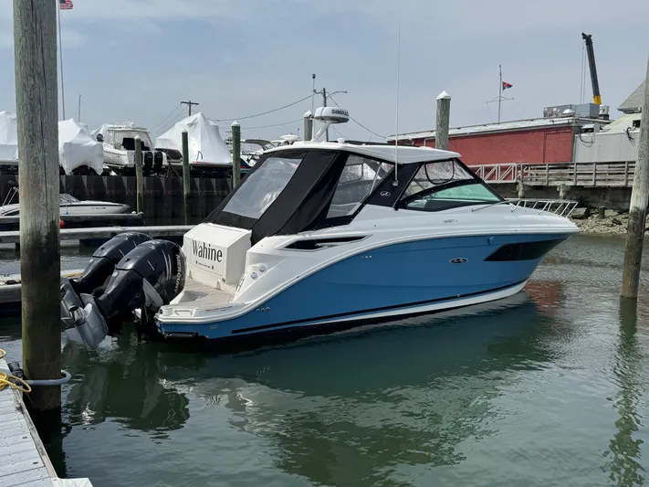Wahine Yacht Photos Pics 2021 Sea Ray Sundancer 320 OB boat docked in marina, featuring sleek design and twin outboard engines.