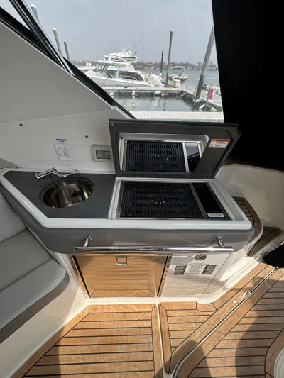 Wahine Yacht Photos Pics 2021 Sea Ray Sundancer 320 OB yacht interior with kitchenette and sink.