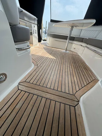 Wahine Yacht Photos Pics 2021 Sea Ray Sundancer 320 OB interior with elegant teak flooring and modern seating.