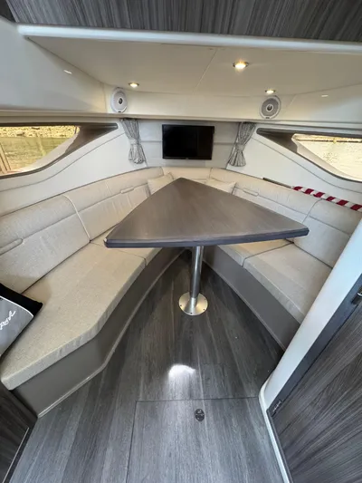 Wahine Yacht Photos Pics Interior of 2021 Sea Ray Sundancer 320 OB with modern seating and triangular table.