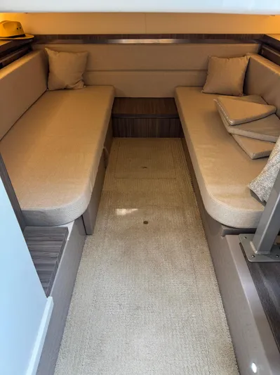 Wahine Yacht Photos Pics 2021 Sea Ray Sundancer 320 OB cabin interior with beige seating and cushions.