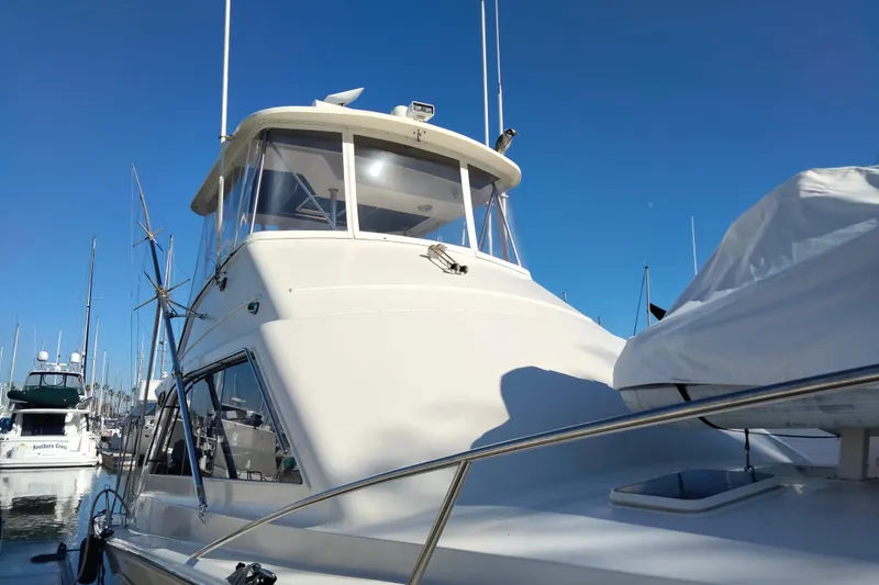 Reel'n In Style Yacht Photos Pics 1988 Ocean 44' Super Sport yacht docked under clear blue sky.