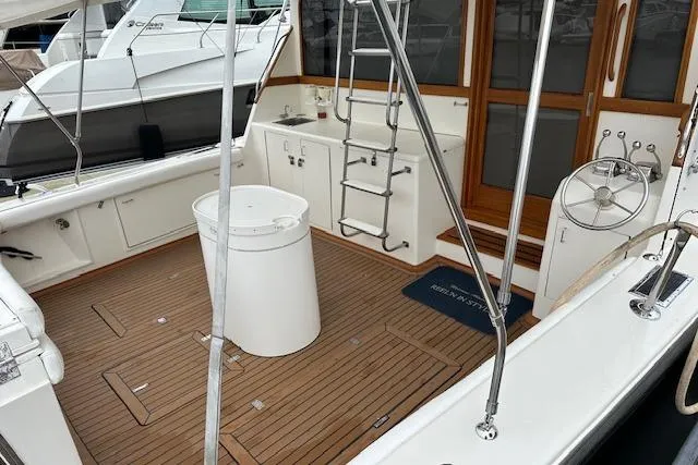 Reel'n In Style Yacht Photos Pics 1988 Ocean 44' Super Sport yacht with teak deck and ladder in the cockpit area.