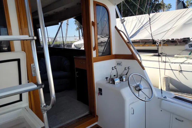 Reel'n In Style Yacht Photos Pics 1988 Ocean 44' Super Sport yacht interior with helm and seating area.
