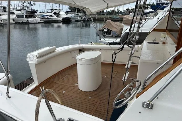 Reel'n In Style Yacht Photos Pics 1988 Ocean 44' Super Sport yacht docked at marina, featuring spacious deck and seating area.