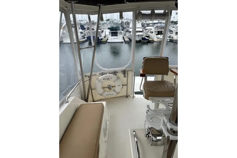 Reel'n In Style Yacht Photos Pics 1988 Ocean 44' Super Sport yacht interior with marina view, featuring seating and life preserver.