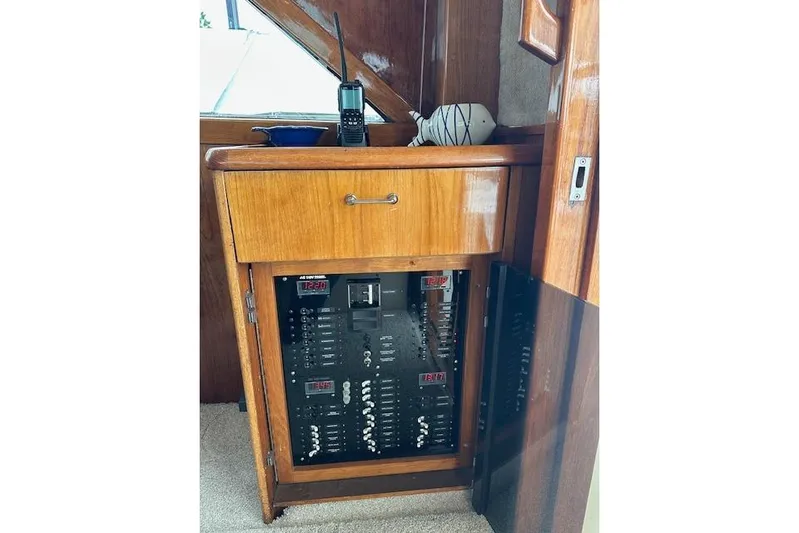 Reel'n In Style Yacht Photos Pics 1988 Ocean 44' Super Sport yacht electrical panel with wooden cabinet and radio.