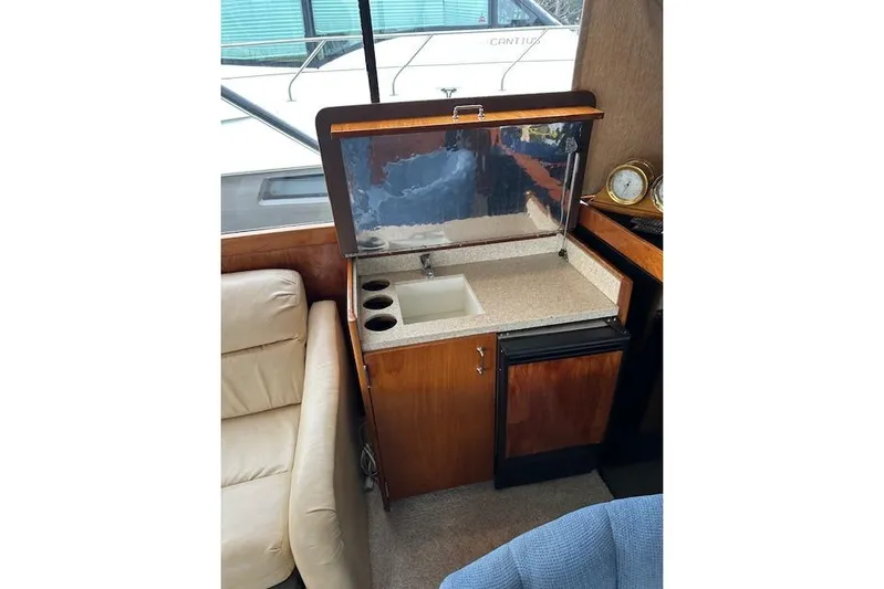 Reel'n In Style Yacht Photos Pics 1988 Ocean 44' Super Sport yacht interior with sink and mini-fridge.