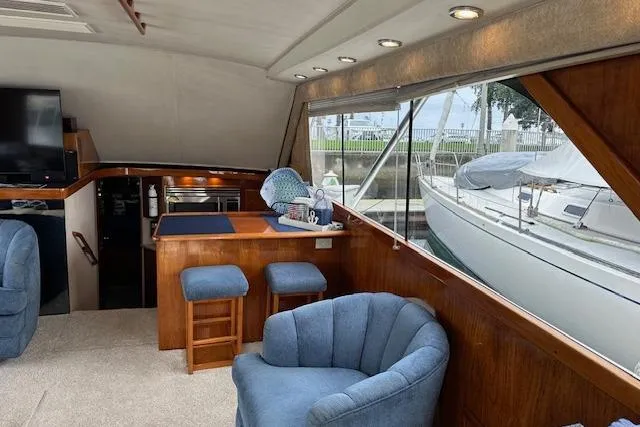 Reel'n In Style Yacht Photos Pics Interior of 1988 Ocean 44' Super Sport yacht with cozy seating and dockside view.