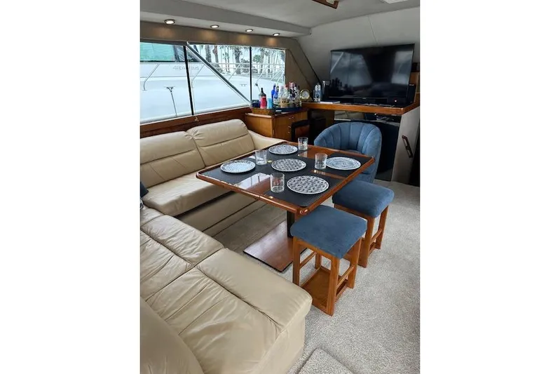 Reel'n In Style Yacht Photos Pics Luxurious interior of 1988 Ocean 44' Super Sport yacht with dining area and seating.